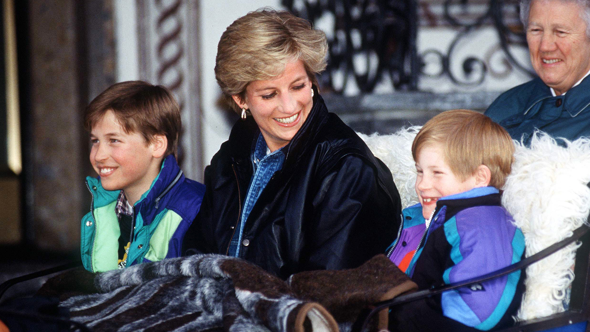 LECH, AUSTRIA - MARCH 30: Princess Diana With Prince William And Prince Henry (harry) In Lech, Austria. They Are Sitting In A Carriage With A Blanket Covering Them. Sitting Behind Is Their Nanny Olga Powell. (Photo by Tim Graham Photo Library via Getty Images)