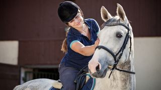 Happy girl on attractive grey horse