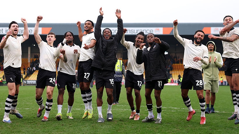 Port Vale players celebrate the teams victory following the Emirates FA Cup Fifth Round match between Port Vale and Sunderland on March 08, 2026 in Burslem, England. 