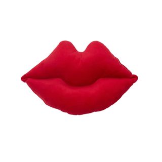 A red lips-shaped throw cushion in red