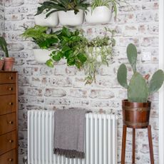 white radiator on brick wall in living space