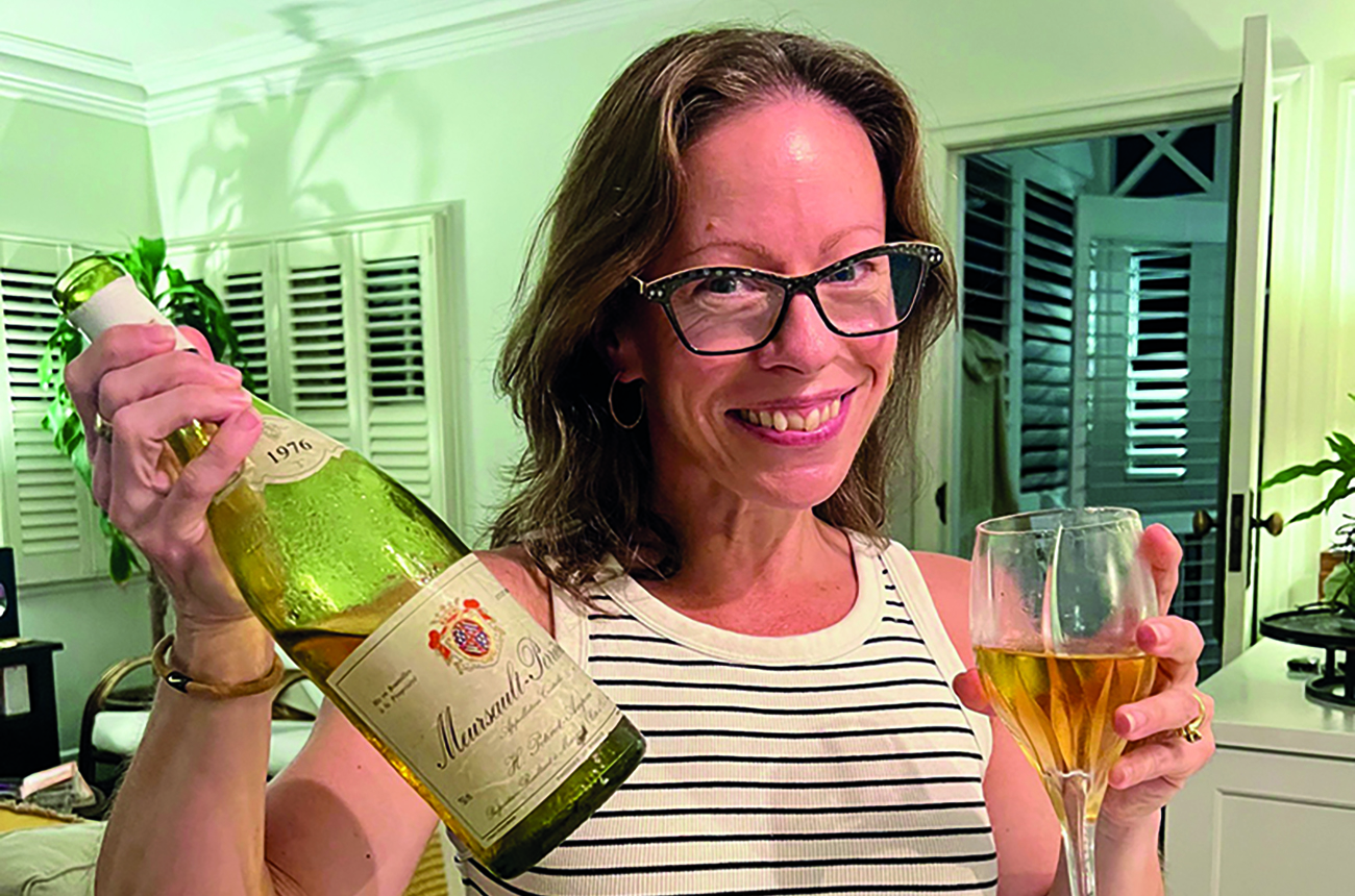 Woman holding bottle of Meursault
