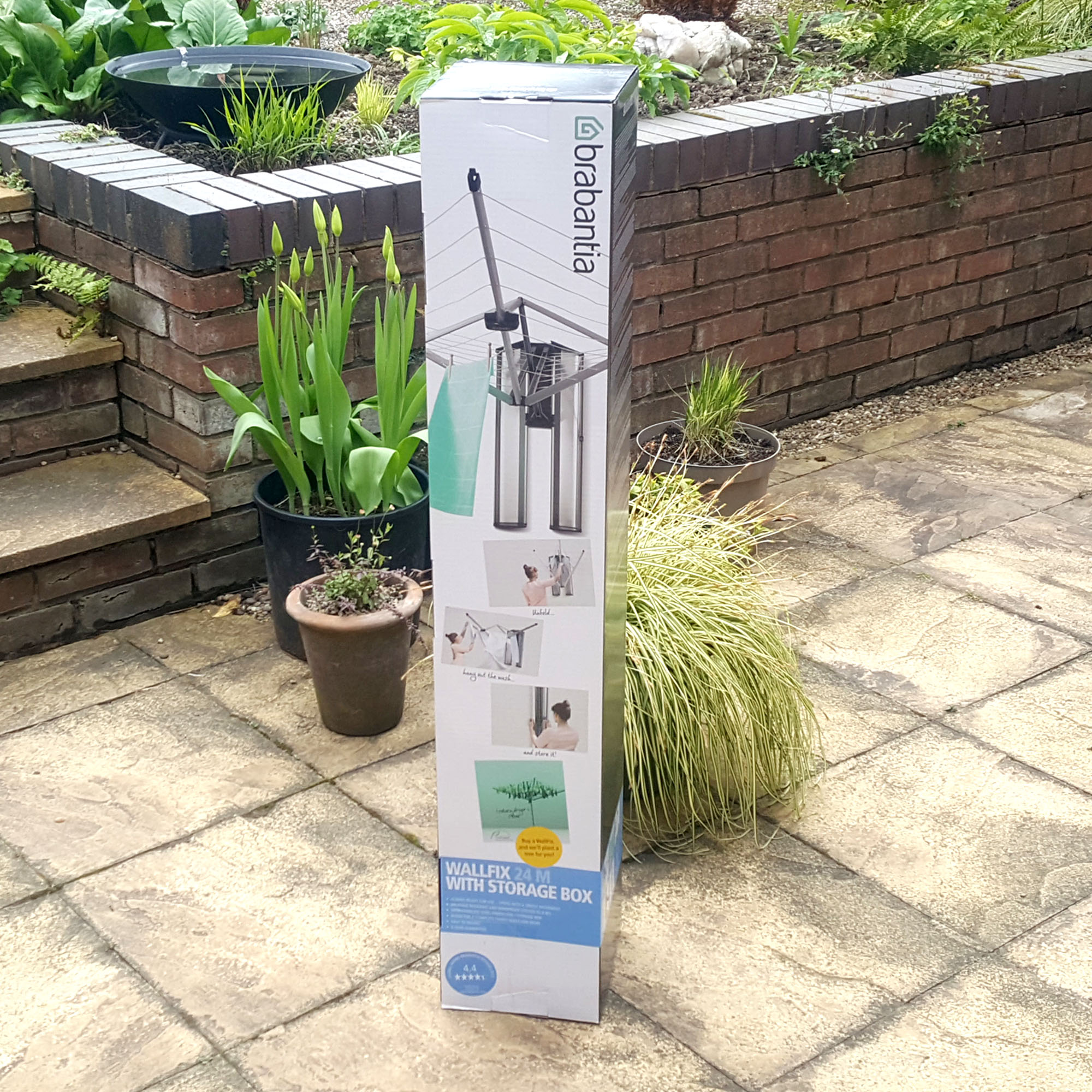 The Brabantia Wallfix Dryer boxed on a paved patio