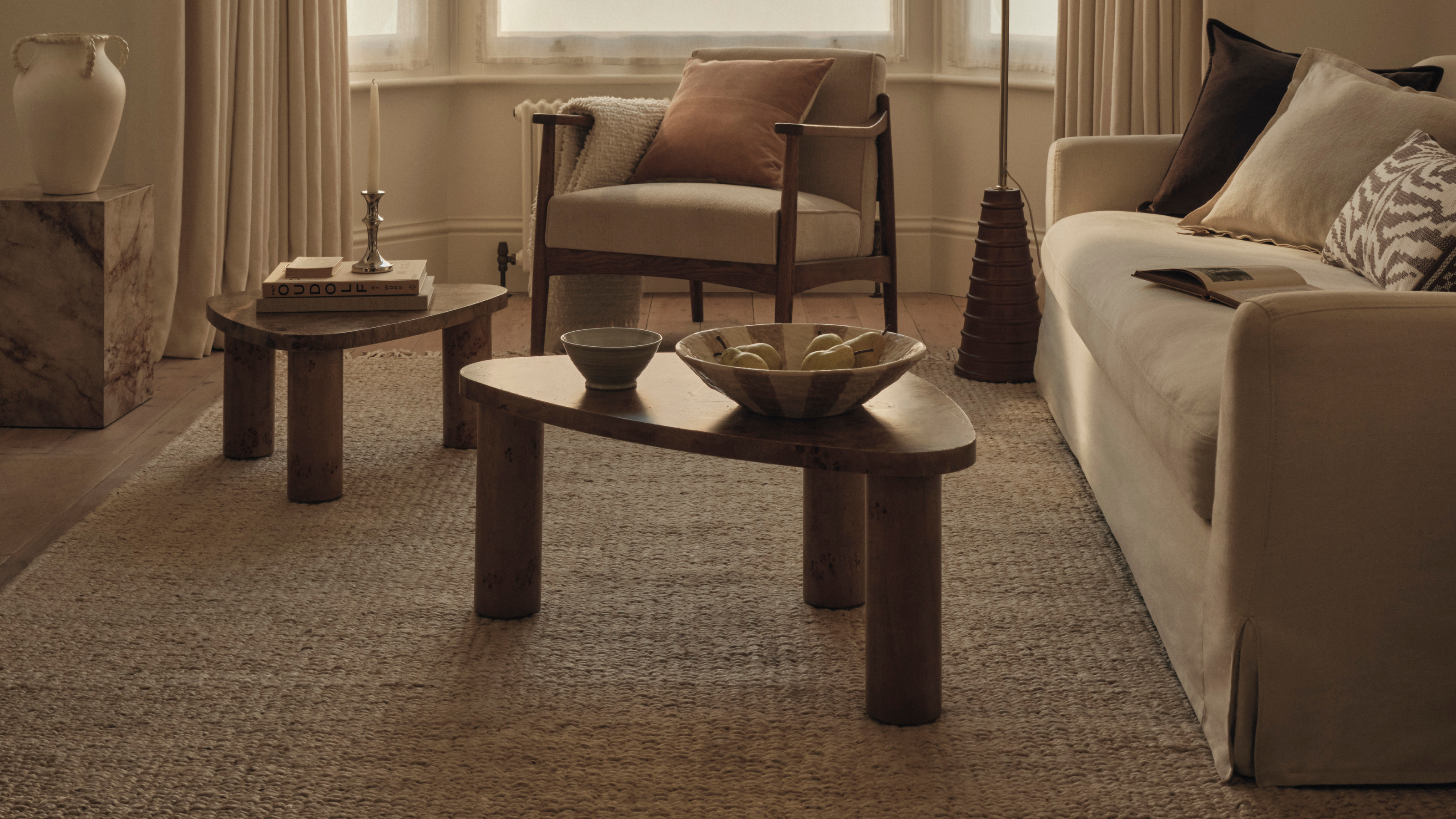 Neutral livging room with two wood coffee table.
