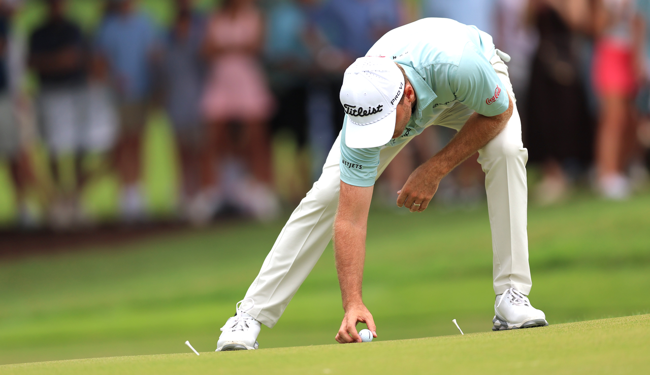 Russell Henley puts a golf ball on the ground