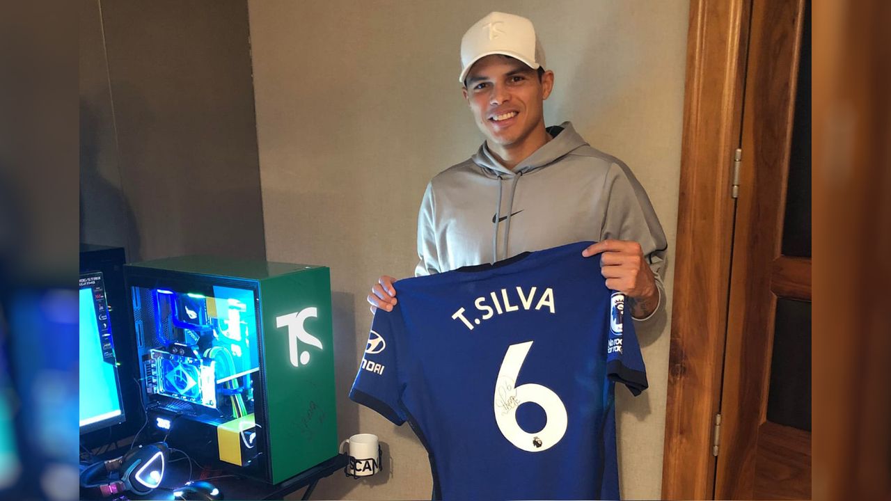 Chelsea FC player Thiago Silva holding jersey next to signed gaming PC