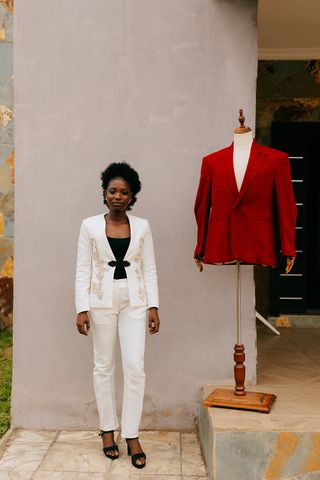 Melody poses next to one of her menswear creations, wearing a suit she made especially for this shoot. She hopes to change attitudes around what is acceptable for women to wear, do and be.
