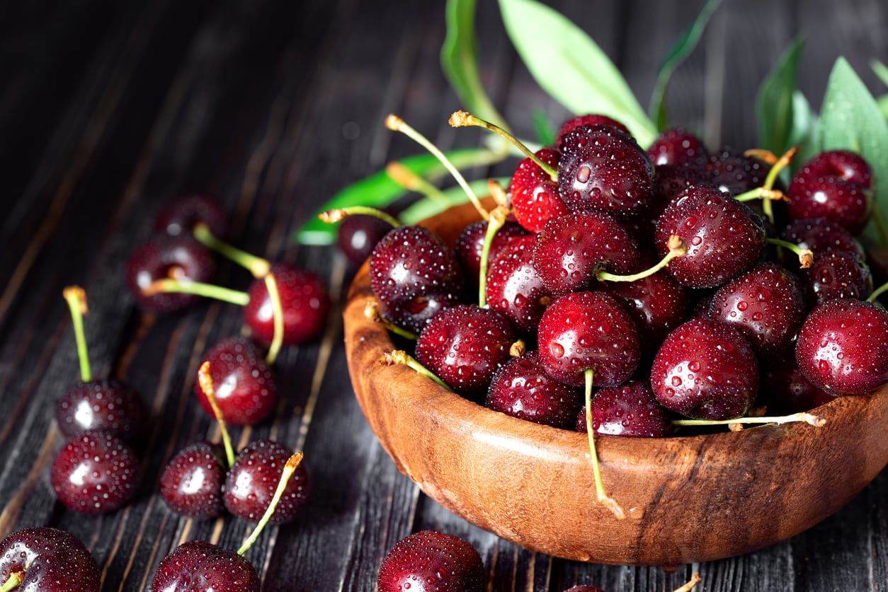 Wooden Bowl Full of Red Attika Cherries