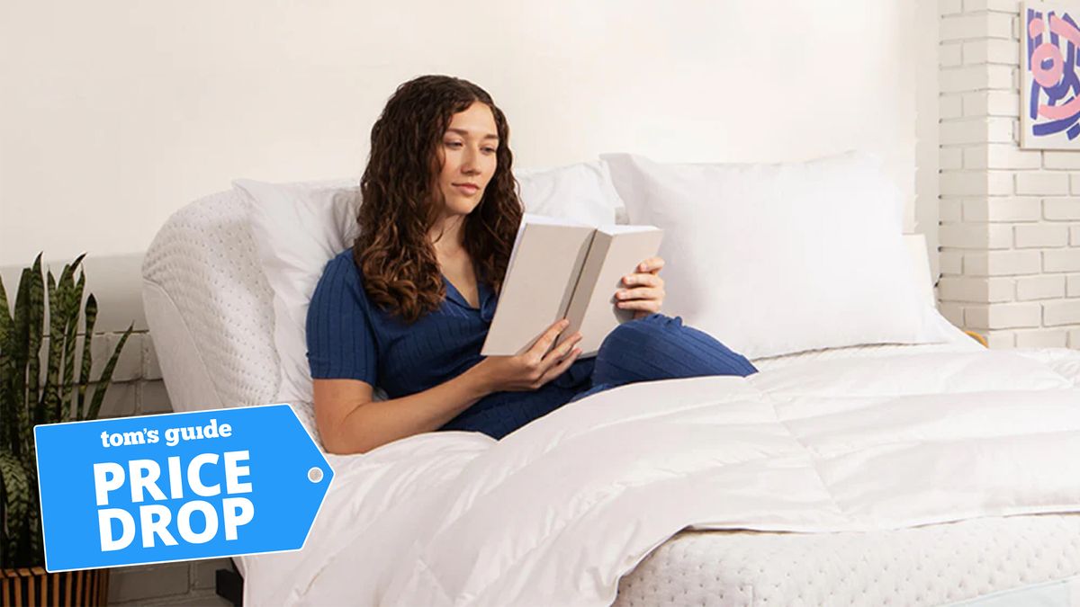 A woman reading a book whilst laying on a Casper adjustable bed with a Tom&#039;s Guide Price Drop badge in the lower left corner