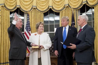 President Trump watches as Rex Tillerson is sworn is as secretary of state