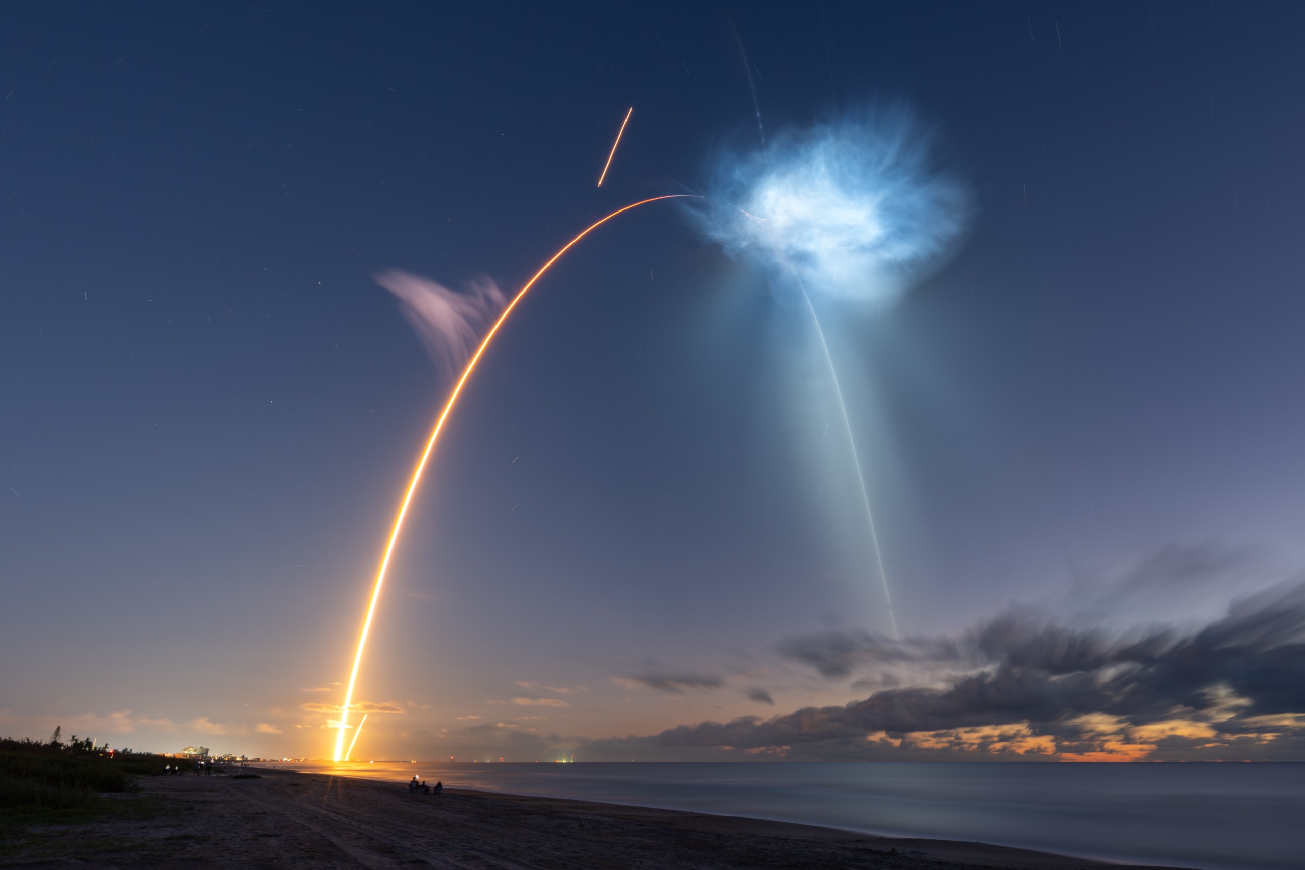 Sunlight hitting exhaust plumes from a SpaceX rocket creates an unusual shape in the sky