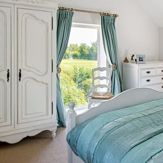 bedroom with white wall large window with curtain and white cupboard
