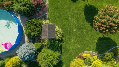 above ground pool with lawn and shrubs