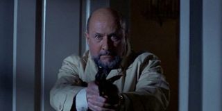 Donald Pleasance as Dr. Loomis in the original Halloween, pointing a gun