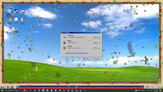 An image of a faux Windows 98 desktop littered with polygonal objects attacking a mouse cursor from game Desktop Survivors 98.