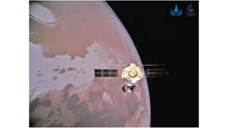 photo of a golden spacecraft in orbit around mars.