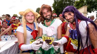 Runners sample wine at the Marathon du Medoc in France