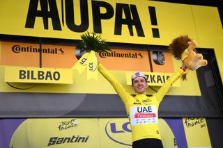 Adam Yates of United Kingdom and UAE Team Emirates celebrates at podium as Yellow Leader Jersey winner during the stage one of the 110th Tour de France 2023