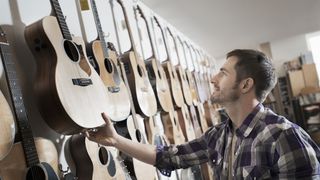 Person browsing in a guitar shop