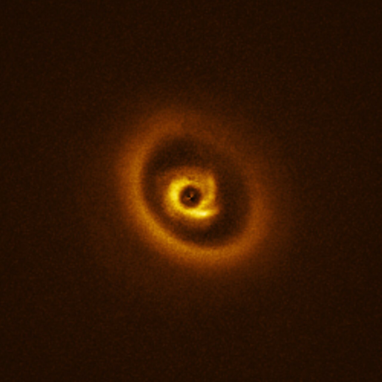 Rings of orange and yellow sit on a dark background