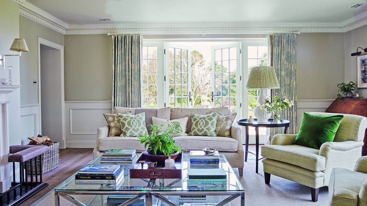 neutral living room with green accents, green cushions, green patterned cushions and blue patterned curtains 