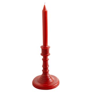 loewe red candle in a tall candlestick shape