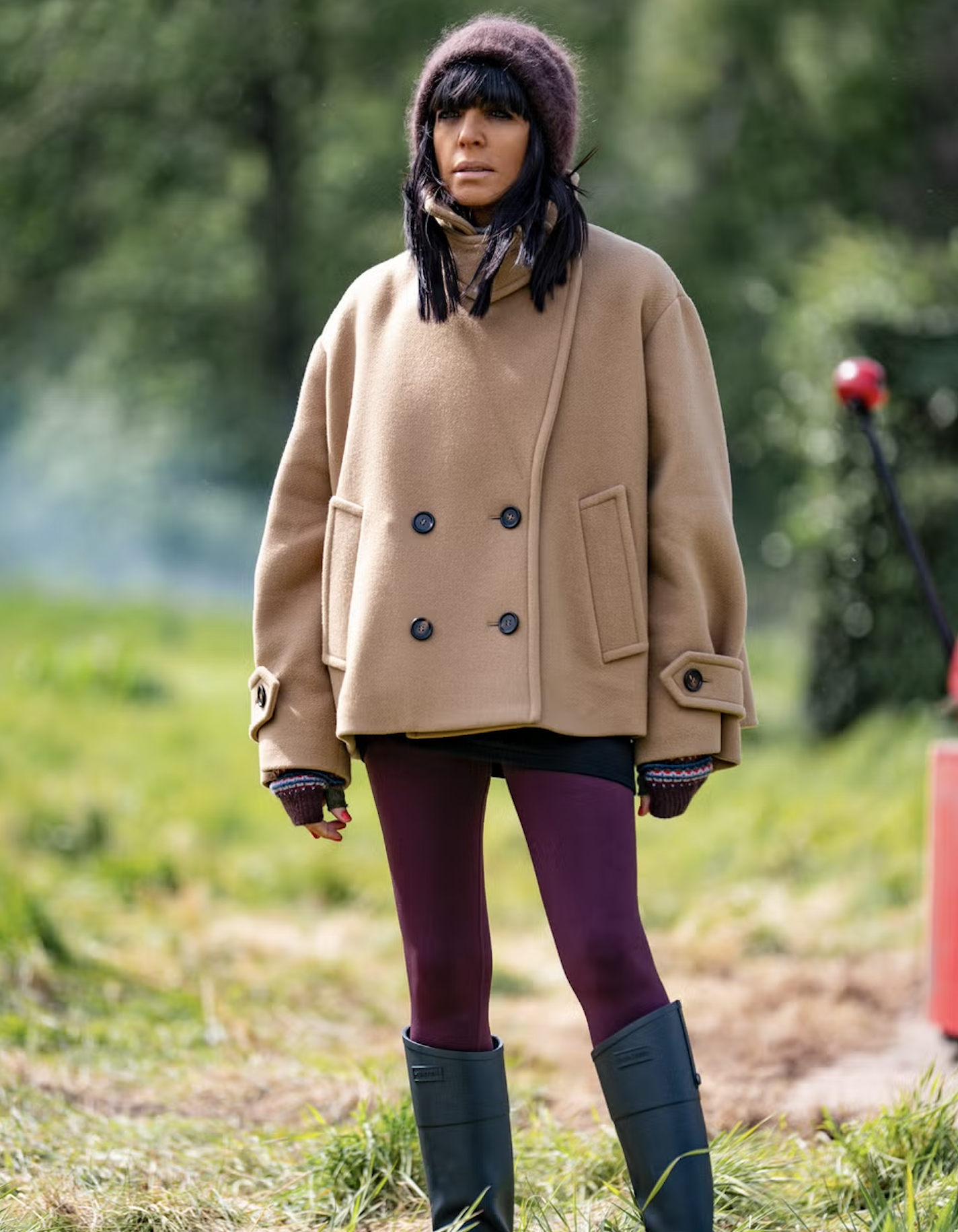 Claudia Winkleman wearing a beige funnel-neck coat