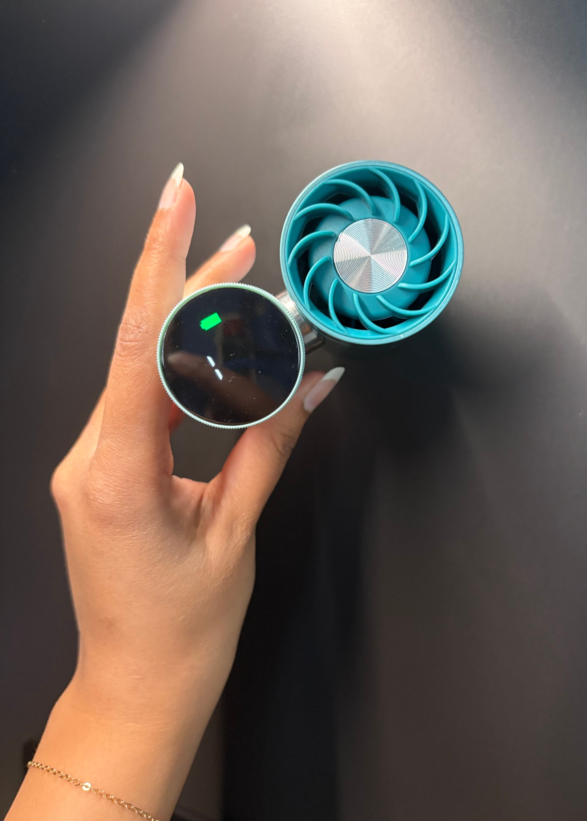 A hand holding the Glacier Shark ChillPill on fan mode