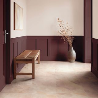 Pink hallway with burgundy wall panelling, wooden bench and rose stone effect LVT flooring