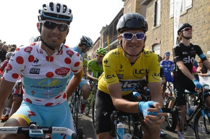 Italy's Valerio Agnoli (L), wearing the best climber's polka dot jersey, and Britain's Geraint Thomas (C), wearing the overall leader's yellow jersey