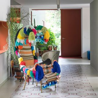 hallway with decorative chair and plants