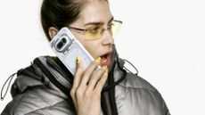 Nothing Phone (4a) used by woman wearing sunglasses