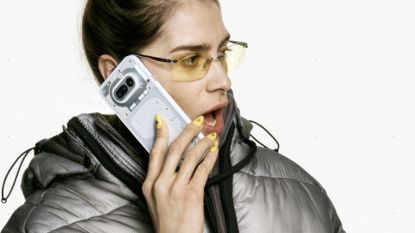 Nothing Phone (4a) used by woman wearing sunglasses