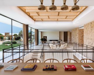 A view of an open plan dining and living area in an Ibiza villa with sunken staircase