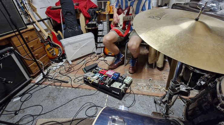 A Pedaltrain Classic 1 pedalboard in a rehearsal room