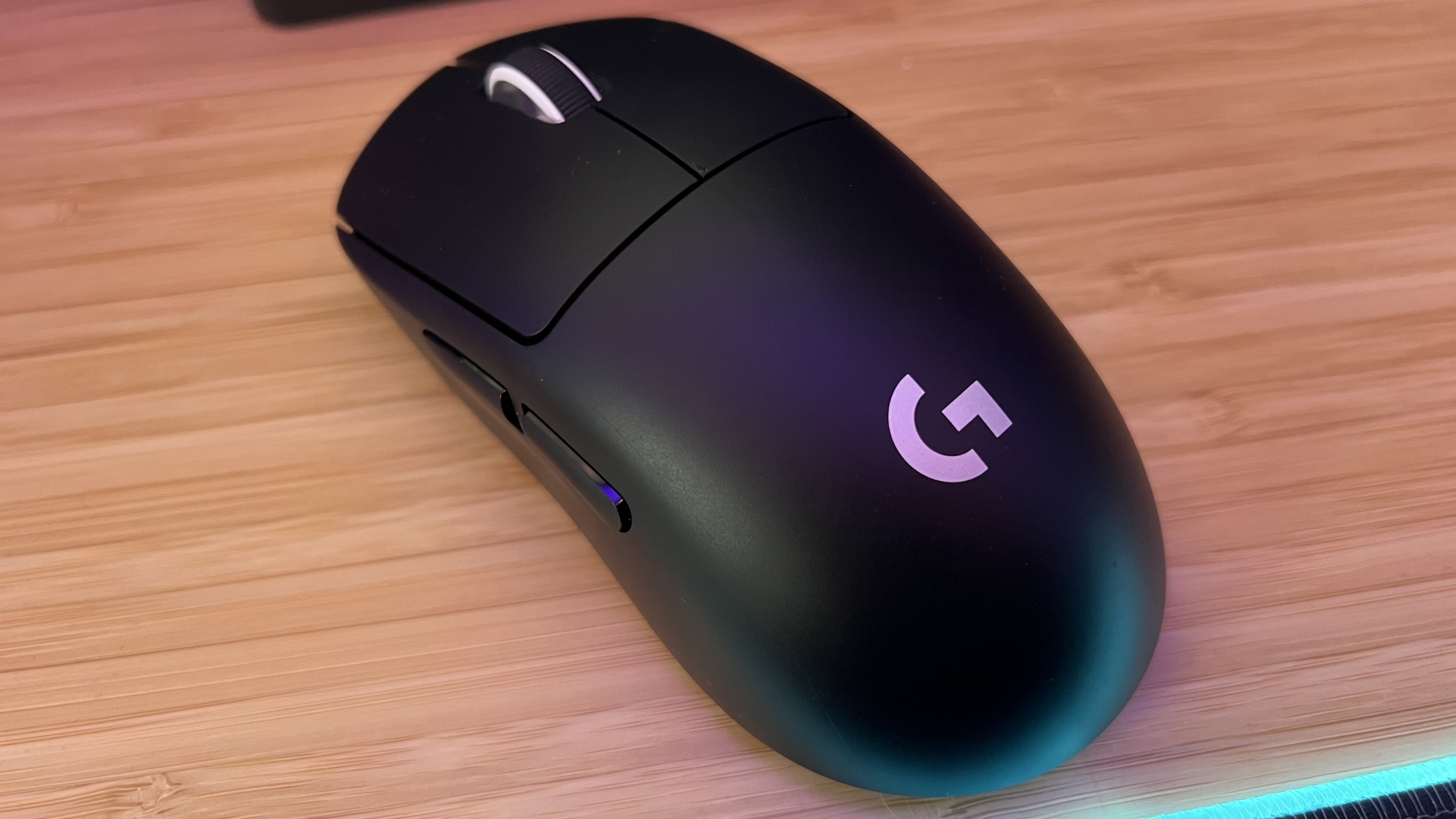 Logitech G Pro X Superlight 2 gaming mouse on a wooden table