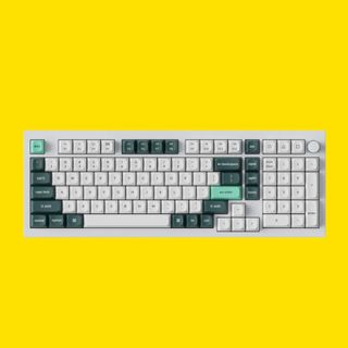 An image of a Keychron Q5 HE wireless keyboard against a yellow background