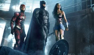 The Flash, Batman, and Wonder Woman looking up at a situation in Justice League.