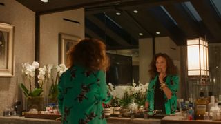 diane von furstenberg looks into a mirror while standing in an opulent bathroom, in the documentary 'Diane von Furstenberg: Woman in Charge'