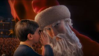 Hero Boy whispers in Santa's ear at the North Pole in The Polar Express.