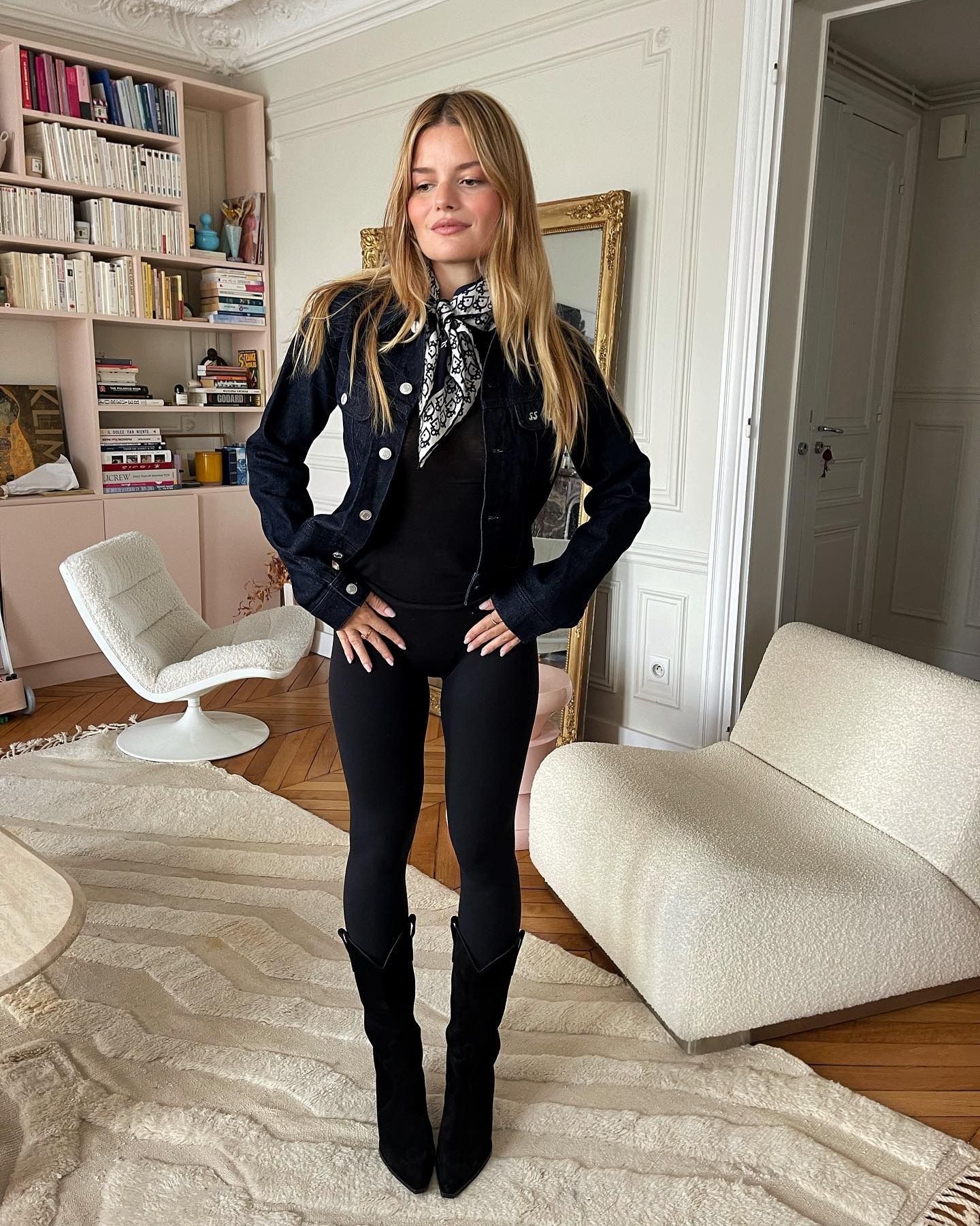 Influencer @sabinasocol wears leggings with knee-high boots.