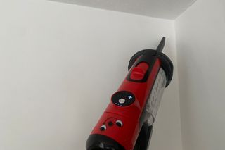 Henry Quick vacuum using crevice tool in corner of ceiling