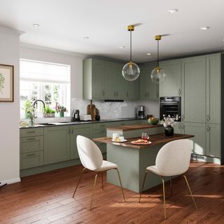 A kitchen with sage green cabinetry and a kitchen island