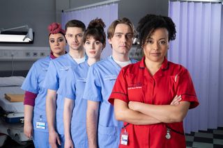 Sarah Seggari, Eddie-Joe Robinson, Anna Chell, Barney Walsh and Jaye Jacobs standing in a line and wearing scrubs