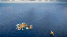 Aerial view of Easter Island in the southeastern Pacific Ocean. We see three separate islands and the horizon.