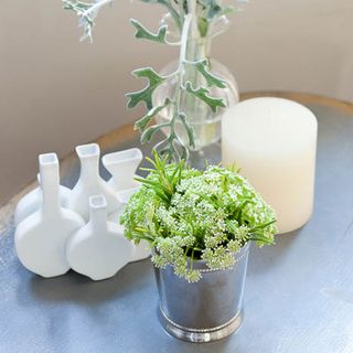 table top display of vases greenery and candle