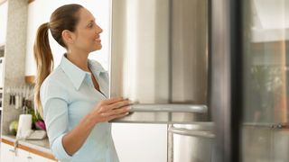 What temperature should a freezer be?: Woman with freezer