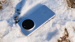 Honor Magic7 Pro phone laying screen down in snow on the ground