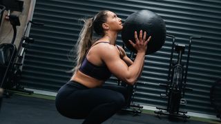 Aimee Cringle performs wall ball with medicine ball