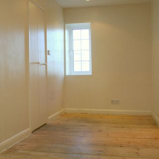 room with with wooden floor and cream wall